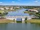 The aerial view showcases a bridge over a lake surrounded by homes and mature trees at 3966 Steer Beach Pl, Kissimmee, FL 34746