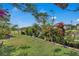 Large backyard with lush landscaping, garden beds, and a well-maintained lawn at 3966 Steer Beach Pl, Kissimmee, FL 34746