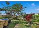 Landscaped backyard with flowering trees, plants, and garden at 3966 Steer Beach Pl, Kissimmee, FL 34746
