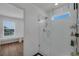 Modern bathroom with glass shower and view into a bedroom at 3966 Steer Beach Pl, Kissimmee, FL 34746