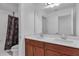 Modern bathroom with double sinks, spacious countertop, and a shower with a decorative curtain at 3966 Steer Beach Pl, Kissimmee, FL 34746
