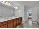 Bathroom featuring double vanity, and view into the adjacent room at 3966 Steer Beach Pl, Kissimmee, FL 34746