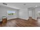 Bright, airy bedroom with wood floors, a large window, and neutral walls at 3966 Steer Beach Pl, Kissimmee, FL 34746