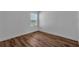 This bedroom boasts a window with a beautiful view and wood-look flooring at 3966 Steer Beach Pl, Kissimmee, FL 34746