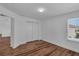 A spacious bedroom featuring hardwood floors, a double closet, and a window at 3966 Steer Beach Pl, Kissimmee, FL 34746