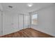 A light-filled bedroom boasts wood-look floors, double closets, and a bright window at 3966 Steer Beach Pl, Kissimmee, FL 34746