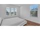 Bright bedroom featuring hardwood floors, arched windows, and a comfortable bed at 3966 Steer Beach Pl, Kissimmee, FL 34746