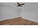 A light-filled bedroom featuring wood-look floors, a ceiling fan, and a closet at 3966 Steer Beach Pl, Kissimmee, FL 34746