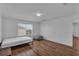 Bright bedroom featuring hardwood floors, a large window, and minimalist decor at 3966 Steer Beach Pl, Kissimmee, FL 34746