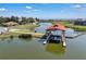 This waterfront home features a covered boat lift and dock with access to a beautiful lake at 3966 Steer Beach Pl, Kissimmee, FL 34746