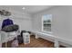 Open closet featuring hardwood floors, a large window, and built-in shelving at 3966 Steer Beach Pl, Kissimmee, FL 34746