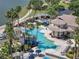 Aerial view of a luxurious community pool featuring a slide, fountains, and ample seating under swaying palm trees at 3966 Steer Beach Pl, Kissimmee, FL 34746