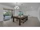 Open dining area with tile flooring, sliding glass doors, recessed lighting, and an elegant chandelier at 3966 Steer Beach Pl, Kissimmee, FL 34746