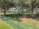 Dog park with multiple agility stations, shade trees, and benches within a fenced enclosure at 3966 Steer Beach Pl, Kissimmee, FL 34746