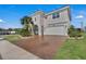 Charming two-story home with a manicured lawn and brick-paved driveway at 3966 Steer Beach Pl, Kissimmee, FL 34746