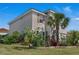 Stunning two-story home featuring a lush, landscaped yard and classic architectural details at 3966 Steer Beach Pl, Kissimmee, FL 34746