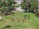 Community fitness area offering various exercise equipment on a well-maintained lawn surrounded by mature trees at 3966 Steer Beach Pl, Kissimmee, FL 34746