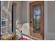 Inviting front entry with a decorative glass door, bench, and charming details at 3966 Steer Beach Pl, Kissimmee, FL 34746