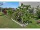 Landscaped backyard with flower beds, lush greenery, and a variety of plants at 3966 Steer Beach Pl, Kissimmee, FL 34746