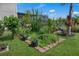 Lush garden featuring diverse plants, greenery, and a stone-bordered flowerbed at 3966 Steer Beach Pl, Kissimmee, FL 34746
