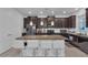 Modern kitchen featuring a granite island with seating and dark wood cabinets at 3966 Steer Beach Pl, Kissimmee, FL 34746