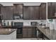 Modern kitchen with stainless steel appliances and granite countertops at 3966 Steer Beach Pl, Kissimmee, FL 34746