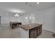 Open kitchen features a center island with granite countertops and pendant lighting at 3966 Steer Beach Pl, Kissimmee, FL 34746
