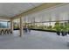 Large screened-in lanai with a seating area, bar, tile flooring, and multiple ceiling fans at 3966 Steer Beach Pl, Kissimmee, FL 34746