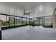 Large screened lanai with a ceiling fan and view of lush landscaping at 3966 Steer Beach Pl, Kissimmee, FL 34746