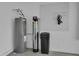 Functional utility area showcasing water heater, filtration system, and storage at 3966 Steer Beach Pl, Kissimmee, FL 34746