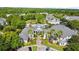 Aerial view of community clubhouse, pool and green space, surrounded by lush landscaping and well-maintained buildings at 430 Southern Pecan Cir # 101, Winter Garden, FL 34787