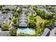 Aerial view of community featuring well-maintained lawns, a pool, mature trees, and an on-site tennis court at 430 Southern Pecan Cir # 101, Winter Garden, FL 34787