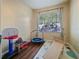 Bright bedroom featuring natural light, wood flooring, and space for play at 430 Southern Pecan Cir # 101, Winter Garden, FL 34787