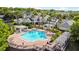 Aerial view of the community pool with lounge chairs, pergolas, and tropical landscaping at 430 Southern Pecan Cir # 101, Winter Garden, FL 34787