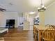 Open-concept dining area with wood floors, a table, and seamless flow to the living spaces at 430 Southern Pecan Cir # 101, Winter Garden, FL 34787