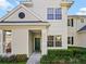 Charming two-story condo with a green front door and well-manicured landscaping at 430 Southern Pecan Cir # 101, Winter Garden, FL 34787