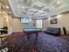 Community game room featuring a pool table, comfortable seating, modern lighting, and vibrant carpet at 430 Southern Pecan Cir # 101, Winter Garden, FL 34787