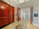 Elegant hallway features tiled floors, decorative ceilings, and ornate trim with an open doorway at the end at 430 Southern Pecan Cir # 101, Winter Garden, FL 34787