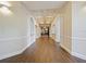 Well-lit hallway with wooden floors, decorative ceilings, and arched entrances, leading to various amenities at 430 Southern Pecan Cir # 101, Winter Garden, FL 34787