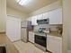 Kitchen with stainless steel appliances, white cabinets, and granite countertops at 430 Southern Pecan Cir # 101, Winter Garden, FL 34787