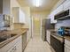 Kitchen with stainless steel appliances, white cabinets, and granite countertops at 430 Southern Pecan Cir # 101, Winter Garden, FL 34787