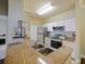Bright kitchen featuring granite counters, stainless steel appliances, and white cabinetry at 430 Southern Pecan Cir # 101, Winter Garden, FL 34787