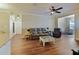 Spacious living room featuring ample seating, wood floors, and abundant natural light at 430 Southern Pecan Cir # 101, Winter Garden, FL 34787