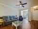 Cozy living room with hardwood floors, ceiling fan, and plenty of natural light at 430 Southern Pecan Cir # 101, Winter Garden, FL 34787