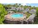 Resort-style pool with pergolas, lounge chairs, and palm trees perfect for relaxation at 430 Southern Pecan Cir # 101, Winter Garden, FL 34787
