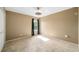 A simple, sunny carpeted bedroom with ample natural light streaming through the window at 4448 Riverton Dr, Orlando, FL 32817