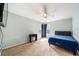 A carpeted bedroom offers a calming retreat, complete with a ceiling fan, study desk, and bed at 4448 Riverton Dr, Orlando, FL 32817
