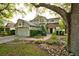 Two-story home with mature landscaping and a two-car garage at 4448 Riverton Dr, Orlando, FL 32817
