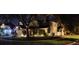 Inviting two-story home with well-lit landscaping enhancing its curb appeal at night at 4448 Riverton Dr, Orlando, FL 32817