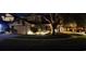 Charming two-story home featuring manicured lawn and landscape lighting enhancing its curb appeal at night at 4448 Riverton Dr, Orlando, FL 32817
